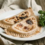 Azerbaijani cooks place a large piece of butter on top, which drips off, soaking the flatbread, making it soft and juicy.