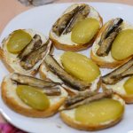 A very tasty recipe for sandwiches with sprats and pickled cucumbers for the holiday table