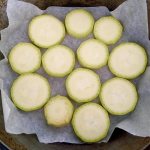 Baked zucchini in the oven without anything on a tray, in circles, whole